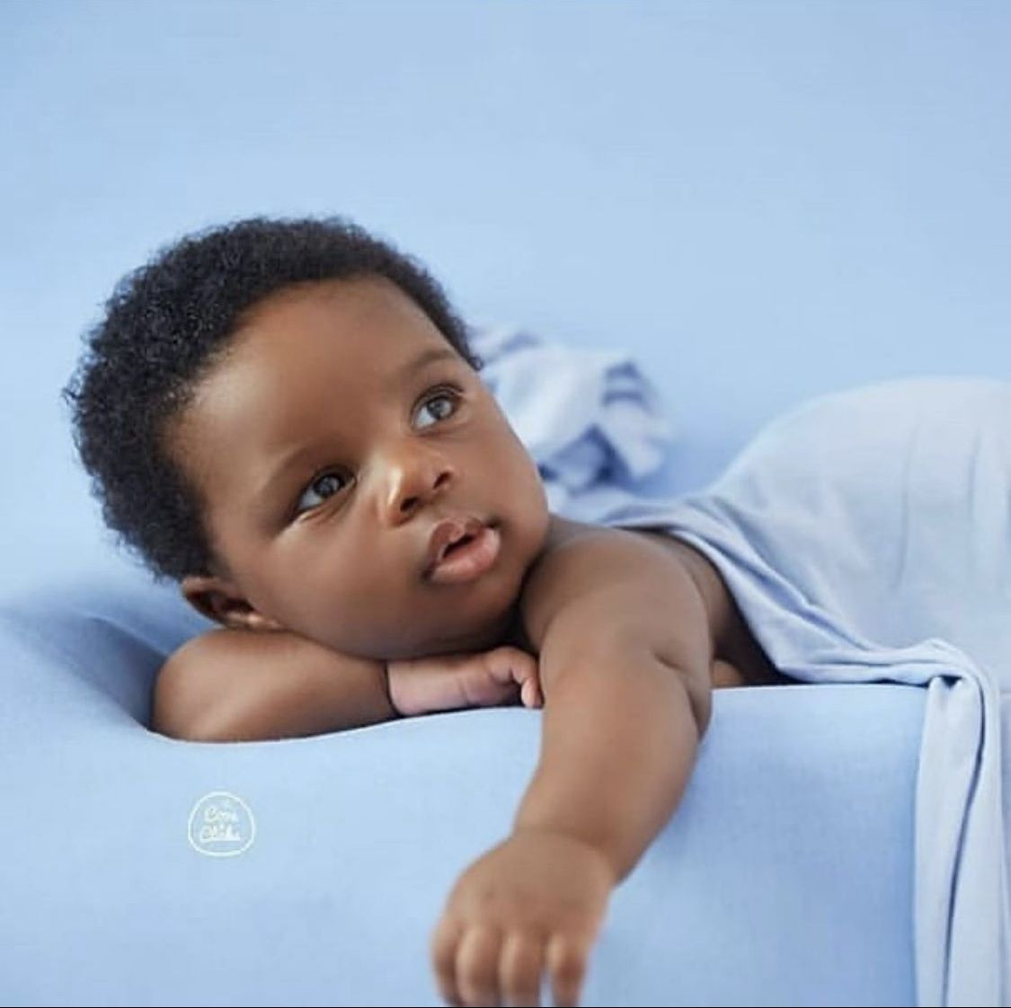 Mother wiping baby's face with a napkin